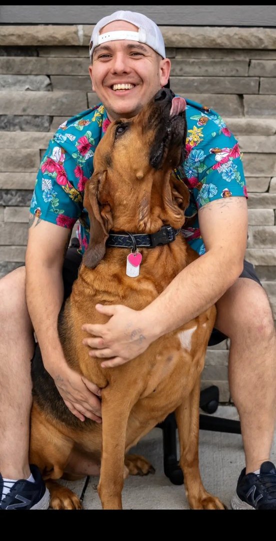 Hugging our bloodhound on the front steps